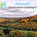 Landschaftsfoto mit dem Text: Miteinander "im Kristall des Erzgebirges"